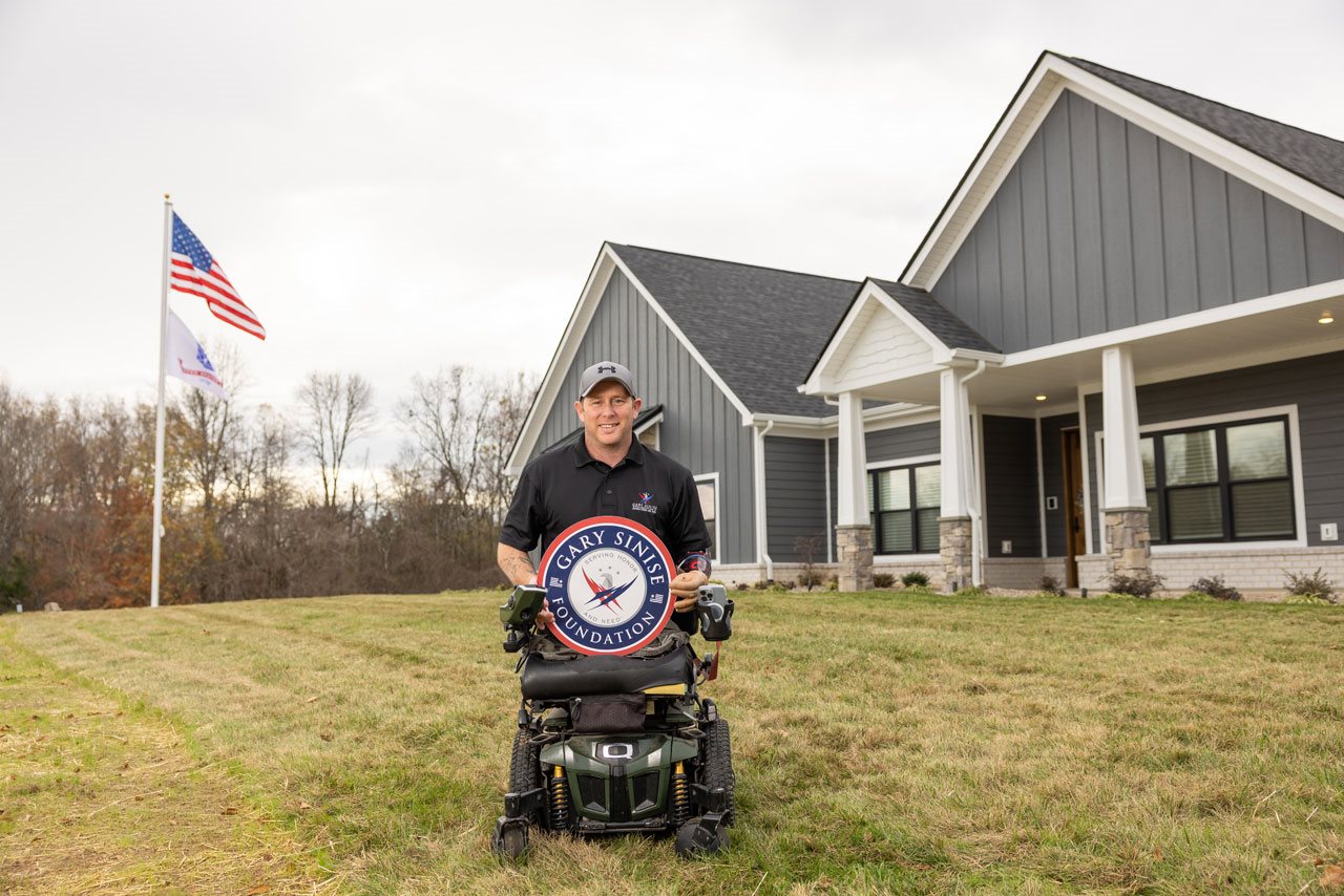 Bryan Anderson in front of his house.