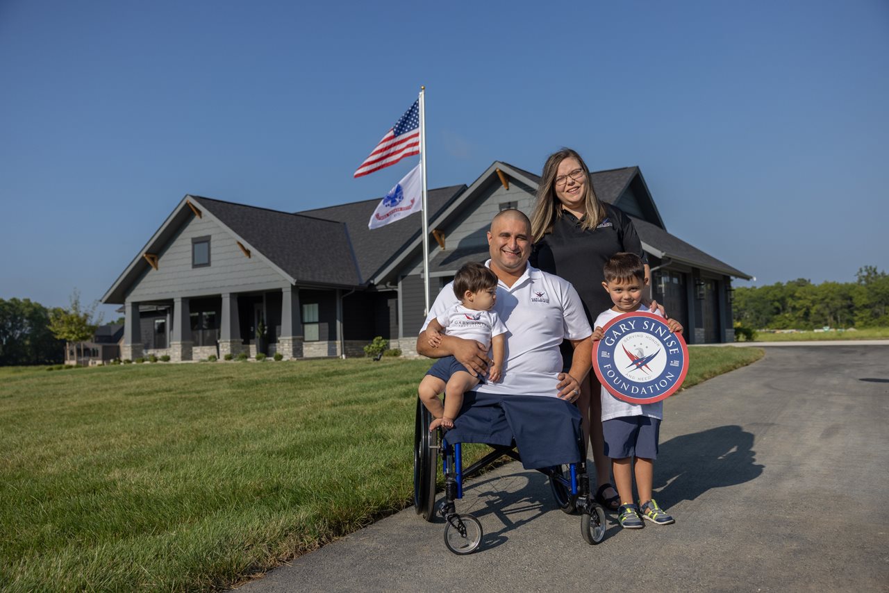 Shane Parsons and family outside their home.